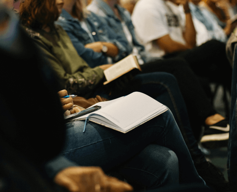 A close up of people sitting at a corporate event