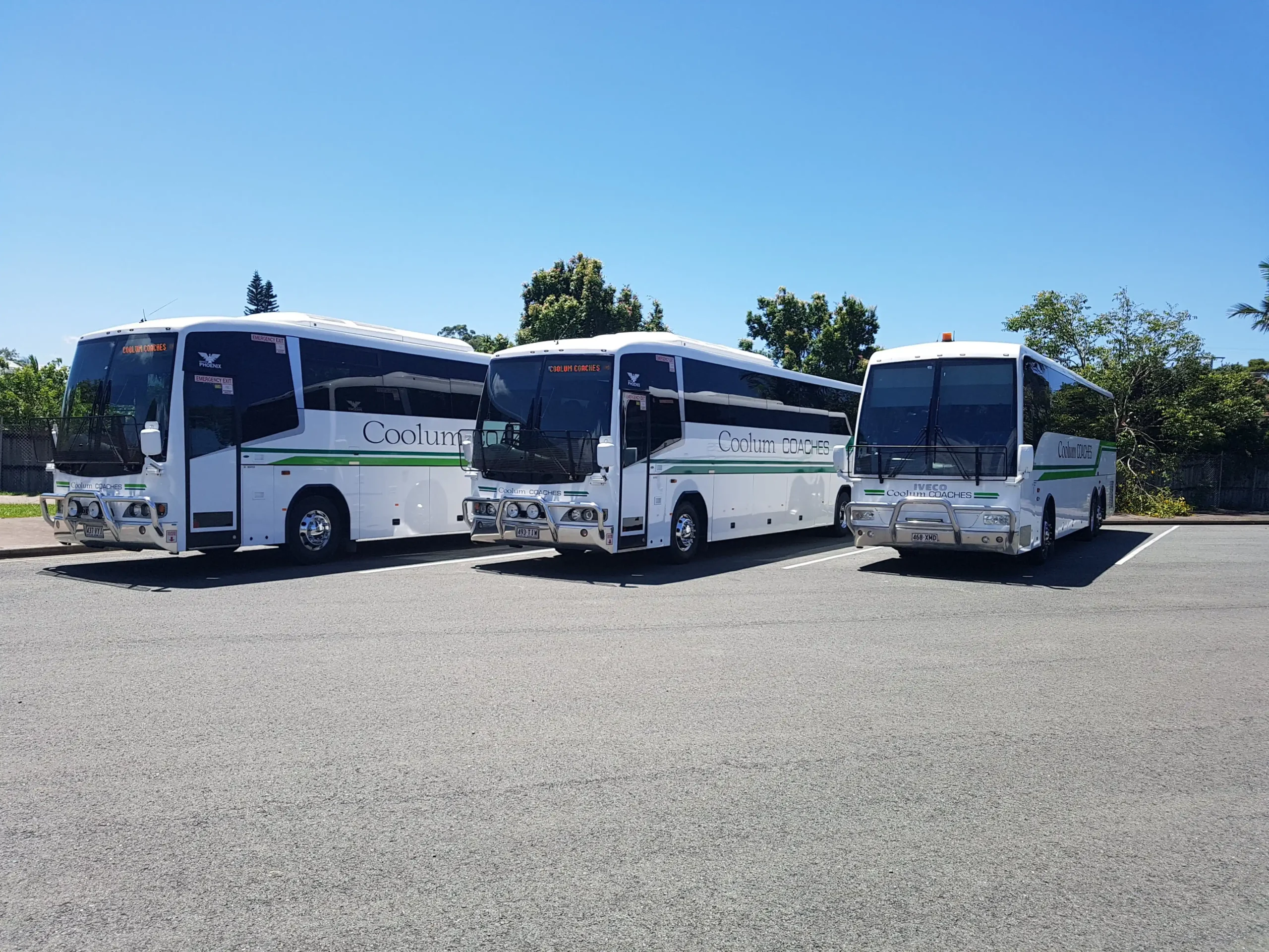 Three coolum coaches buses lined up in a car park