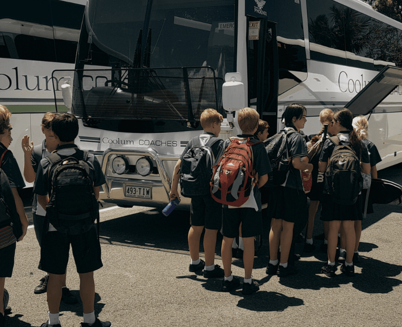 School students hopping onto a coolum coaches school bus